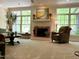 Spacious living room with fireplace, large windows, and comfortable seating area at 1425 Bascomb Dr, Raleigh, NC 27614