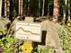 A marked sign post for the North Carolina 'Mountains to Sea' trail is nestled in a densely wooded area at 1425 Bascomb Dr, Raleigh, NC 27614