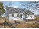 The back of the house with an access door to the backyard with mature trees at 1432 E Stonemason Dr, Fuquay Varina, NC 27526