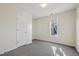 Bedroom with neutral paint, carpeting, a window, and a closet door at 1432 E Stonemason Dr, Fuquay Varina, NC 27526