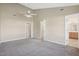 Spacious bedroom with vaulted ceiling, a ceiling fan, and access to a bathroom at 1432 E Stonemason Dr, Fuquay Varina, NC 27526