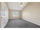 Bright bedroom with a ceiling fan, carpeted floor, and multiple windows for natural light at 1432 E Stonemason Dr, Fuquay Varina, NC 27526
