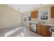 Bright kitchen dining area with a chandelier, stainless steel appliances, and oak cabinets at 1432 E Stonemason Dr, Fuquay Varina, NC 27526