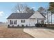 Charming single-story home with a well-maintained yard and a long concrete driveway at 1432 E Stonemason Dr, Fuquay Varina, NC 27526