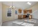 Eat-in kitchen featuring stainless steel appliances, oak cabinets, tile flooring, and natural light at 1432 E Stonemason Dr, Fuquay Varina, NC 27526