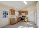 Bright kitchen with stainless steel appliances, oak cabinets, white countertops, and tile floors at 1432 E Stonemason Dr, Fuquay Varina, NC 27526
