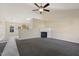 Bright living room featuring a fireplace, ceiling fan, and neutral-toned walls and carpeting at 1432 E Stonemason Dr, Fuquay Varina, NC 27526
