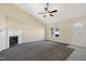 Spacious living room with a vaulted ceiling, fireplace, ceiling fan, and an entrance door at 1432 E Stonemason Dr, Fuquay Varina, NC 27526