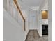 Hallway with hardwood floors, stairs, and a glimpse into the kitchen at 1442 Barton Place Dr, Raleigh, NC 27608