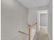 Upstairs hallway features a wooden railing, carpeted floor, and access to bedrooms and other living spaces at 1442 Barton Place Dr, Raleigh, NC 27608