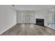 Spacious living room with hardwood floors, fireplace, and sliding glass doors leading to the outside at 1442 Barton Place Dr, Raleigh, NC 27608