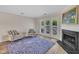 Bright living area featuring a fireplace, hardwood floors, and sliding glass doors to the outside at 1442 Barton Place Dr, Raleigh, NC 27608