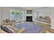 Living room with fireplace, hardwood floors, access to the outdoors and a mirrored wall at 1442 Barton Place Dr, Raleigh, NC 27608
