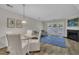 A dining and living room with a fireplace and access to the outdoors is lit by natural light at 1442 Barton Place Dr, Raleigh, NC 27608