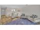A living room and dining room with hardwood floors features neutral furniture and blue rug at 1442 Barton Place Dr, Raleigh, NC 27608