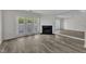 Bright living room with wood floors, fireplace, and access to outdoor space through double doors at 1442 Barton Place Dr, Raleigh, NC 27608