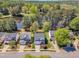 An aerial view of residential homes that are well manicured and have driveways that lead to garages and beautiful landscaping at 145 Ryder Cup Cir, Raleigh, NC 27603