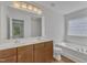 Bright bathroom with a double vanity sink, soaking tub, and an additional window for added light at 145 Ryder Cup Cir, Raleigh, NC 27603