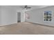 Bedroom with neutral carpet, a ceiling fan, and two windows letting in lots of natural light at 145 Ryder Cup Cir, Raleigh, NC 27603