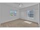 Bright, carpeted bedroom with paneling and multiple windows offering lots of natural light at 145 Ryder Cup Cir, Raleigh, NC 27603