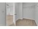 Walk-in closet featuring neutral carpeting, a wire rack system, and an open doorway at 145 Ryder Cup Cir, Raleigh, NC 27603