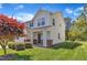 Charming two-story home with a well-manicured front lawn and a two-car garage on a sunny day at 145 Ryder Cup Cir, Raleigh, NC 27603