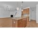 Bright kitchen with island, granite countertops, pendant lights, and view into the living room at 145 Ryder Cup Cir, Raleigh, NC 27603