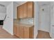 Stylish kitchen featuring granite counters, tile backsplash, and custom wood cabinets at 145 Ryder Cup Cir, Raleigh, NC 27603