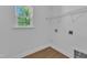 Practical laundry room with window, hook ups and wire shelving for easy organization at 145 Ryder Cup Cir, Raleigh, NC 27603