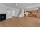 Spacious open floor plan living room with fireplace and modern kitchen with wooden cabinets at 145 Ryder Cup Cir, Raleigh, NC 27603
