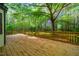 Wooden back deck overlooking a lush, green backyard, perfect for outdoor entertaining at 15 Pine Ridge, Pittsboro, NC 27312