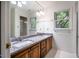 Bathroom featuring double sinks with granite countertop and white tile floor at 15 Pine Ridge, Pittsboro, NC 27312