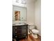 Bathroom with vanity, toilet, and view of stairs at 15 Pine Ridge, Pittsboro, NC 27312