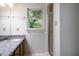 Bright bathroom featuring granite countertop, glass-enclosed shower, and white tile floor at 15 Pine Ridge, Pittsboro, NC 27312
