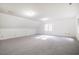 Spacious carpeted bonus room with natural light, offering versatile space for various activities and relaxation at 15 Pine Ridge, Pittsboro, NC 27312