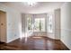 Dining room featuring hardwood floors, white trim, and a large bay window at 15 Pine Ridge, Pittsboro, NC 27312