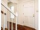 Welcoming entryway features hardwood floors, a white door and access to the staircase at 15 Pine Ridge, Pittsboro, NC 27312