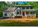 Charming two-story home with a welcoming front porch and vibrant red front door at 15 Pine Ridge, Pittsboro, NC 27312