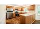 Cozy kitchen featuring stainless steel appliances and light oak cabinets at 15 Pine Ridge, Pittsboro, NC 27312