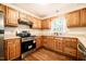Well-lit kitchen featuring stainless steel appliances and wood cabinets at 15 Pine Ridge, Pittsboro, NC 27312