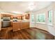 Bright kitchen with hardwood floors, stainless steel appliances, and large windows at 15 Pine Ridge, Pittsboro, NC 27312