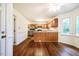 Open kitchen and dining area with hardwood floors, wood cabinets, and stainless steel appliances at 15 Pine Ridge, Pittsboro, NC 27312
