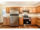 Functional kitchen featuring stainless steel appliances and wood cabinets at 15 Pine Ridge, Pittsboro, NC 27312