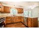 Traditional kitchen with wood cabinets, stainless steel appliances, and hardwood flooring at 15 Pine Ridge, Pittsboro, NC 27312