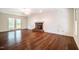 Spacious living room with hardwood floors, fireplace, and sliding door to outdoor space at 15 Pine Ridge, Pittsboro, NC 27312