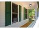 Inviting porch view highlighting green shutters and natural light at 15 Pine Ridge, Pittsboro, NC 27312