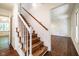 Elegant wooden staircase with white banister and warm, inviting natural light at 15 Pine Ridge, Pittsboro, NC 27312