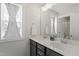 Bright bathroom with double vanity, quartz countertop, and framed mirrors at 1526 Millrock Trl, Wendell, NC 27591