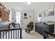 Charming Bedroom with a crib, dresser, and cozy rocking chair at 1526 Millrock Trl, Wendell, NC 27591