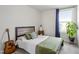 Cozy bedroom featuring natural light from the window, accent plant, and stylish decor at 1526 Millrock Trl, Wendell, NC 27591